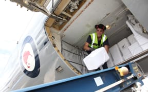 LAC Zinzan Currey unloads water containers from a RNZAF Boeing 757 at Bauerfield Airport, Port Vila, Vanuatu, part of an 11 tonne delivery of relief supplies for Ambae Island.