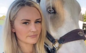 A woman with her horse.
