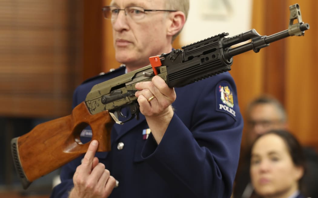 Acting Superintendant Michael McIlraith demonstrates how semi-automatic weapons can be illegally modified