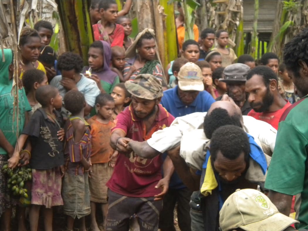 Husband and father is carried to his grave after dying in the bush when he went to make sago.
He was hungry and weak and trying to feed his family.