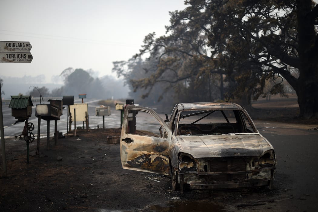 A burnt vehicle on Quinlans street after an overnight bushfire in Quaama in Australia's New South Wales state on January 6, 2020.
