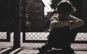 silhouette of Sad teen boy outdoor playground. Feeling depressed