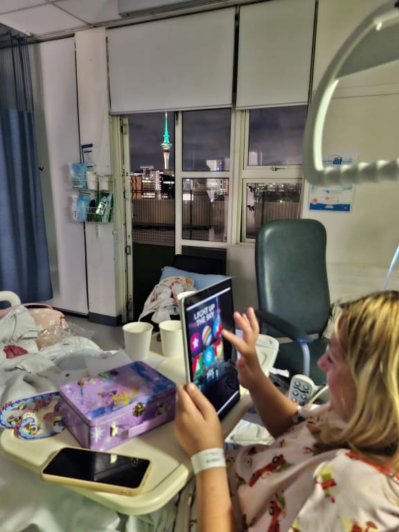 Starship patients use iPad to light up Sky Tower.