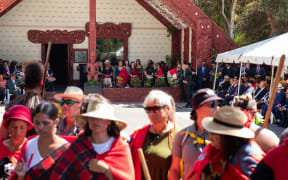 Te Tai Tokerau wahine stand with their backs as Tama Potaka speaks
