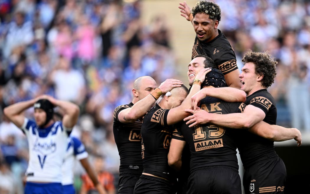 Liam Henry of the Panthers (centre) celebrates with teammates after scoring a try during the NRL Semi-Final match against the Canterbury Bankstown Bulldogs