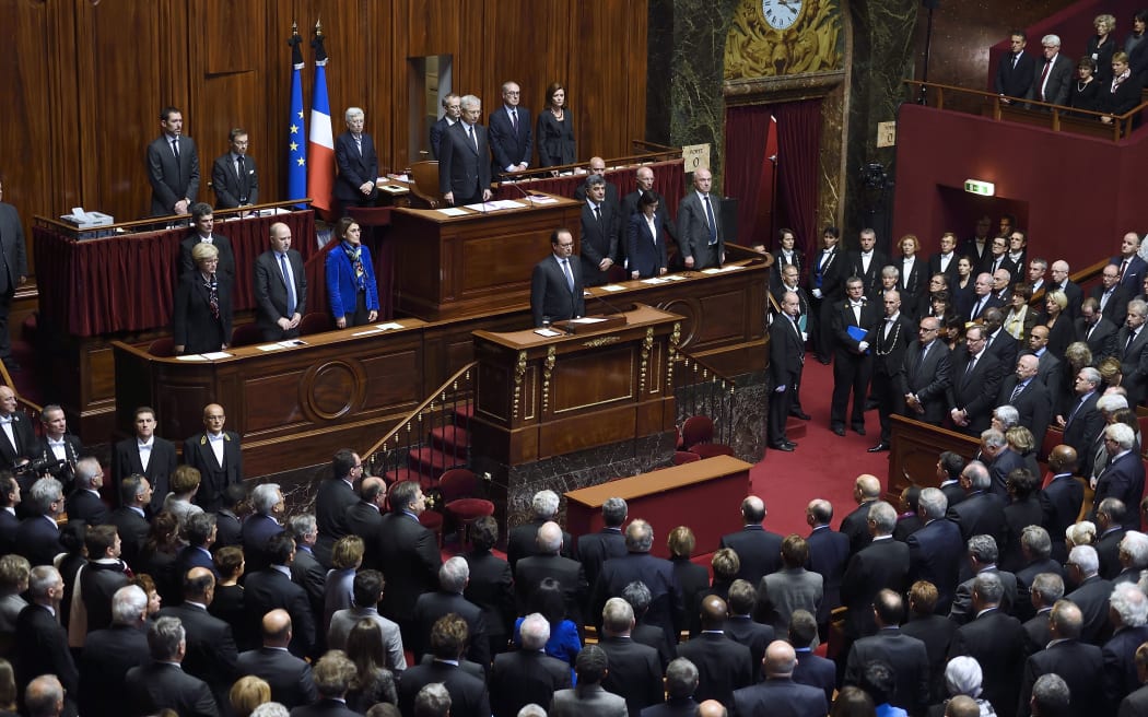President Francois Hollande (centre) and members of Parliament observe a minute of silence on 16 November 2015, in tribute to the victims of 13 November Paris attacks.