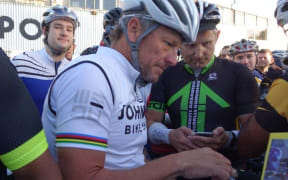 Lance Armstrong signs autographs at Mechanics Bay in Auckland.