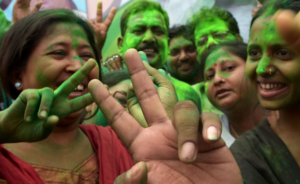 Supporters of Trinamool Congress (TMC) celebrate election results near the house of party supremo and chief minister of eastern West Bengal state.