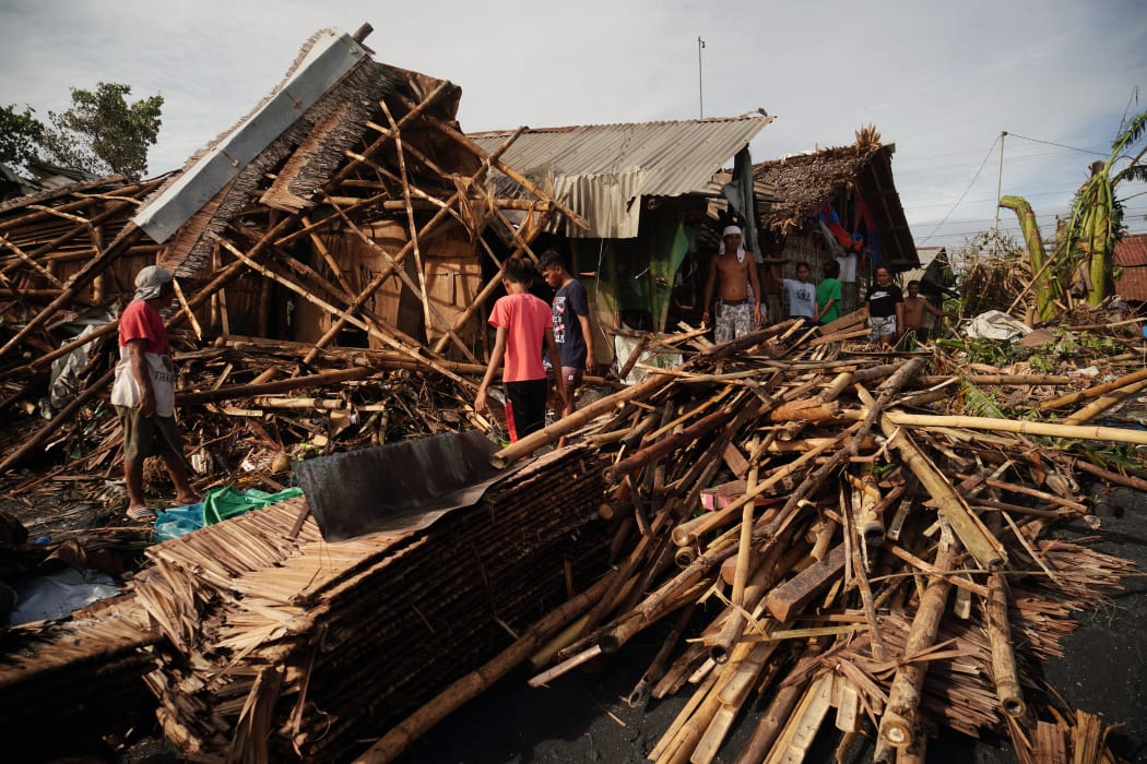 Residents salvage belongings from their destroyed homes in the coastal town of Dulag in Leyte province.