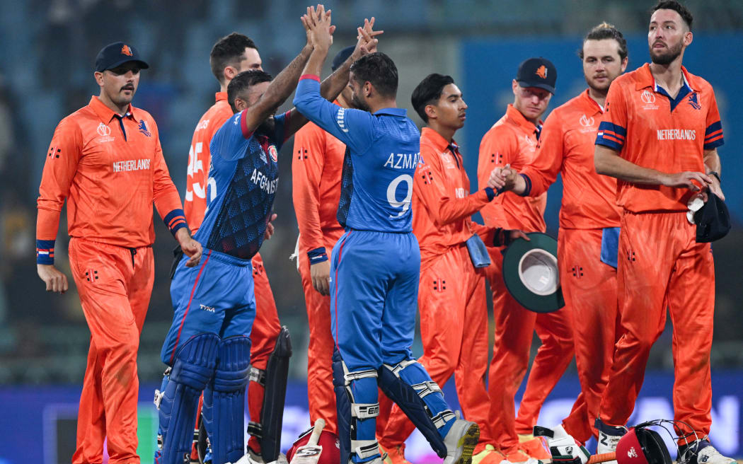 Afghanistan's captain Hashmatullah Shahidi (2L) and Azmatullah Omarzai (3L) celebrate their win at the end of the 2023 ICC Men's Cricket World Cup one-day international (ODI) match against Netherlands at the Ekana Cricket Stadium in Lucknow on November 3, 2023. (Photo by Arun SANKAR / AFP) / -- IMAGE RESTRICTED TO EDITORIAL USE - STRICTLY NO COMMERCIAL USE --