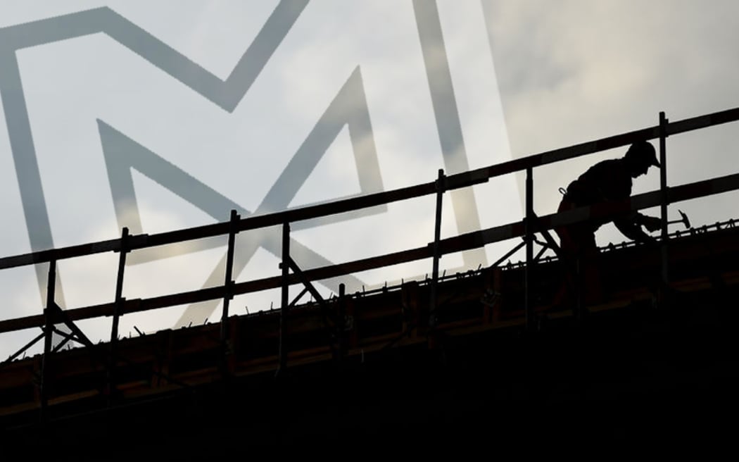 construction worker silhouette on a construction with coudy sky on background