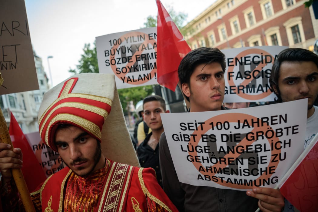 Turkish nationalist protesters wearing Ottoman clothes shout slogans against Germany and hold placards reading "the biggest lie in 100 years is the Armenian genocide" during a protest against Germany on June 2, 2016 in front of the Germany consulate in Istanbul