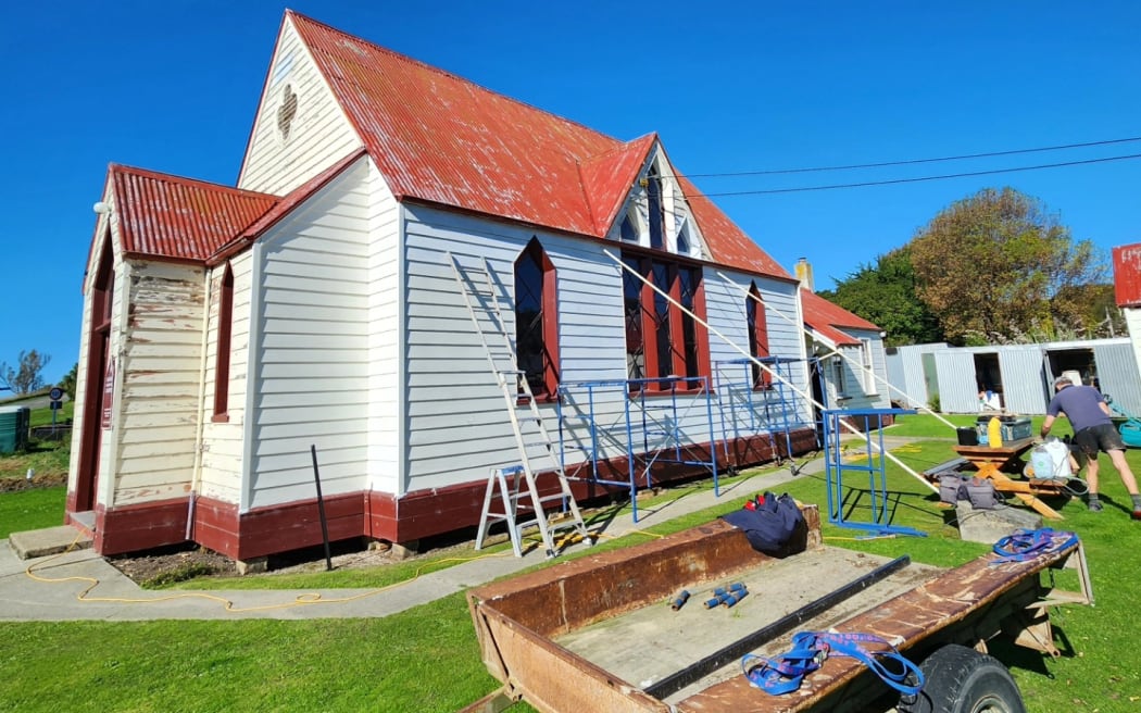 Michael Simpson working on the exterior of the Kakanui Church.
An Otago couple have spent six years restoring a timber Presbyterian church in Kakanui, designed by architect Robert Arthur Lawson, which has now been recognised as a Category 1 historic place.