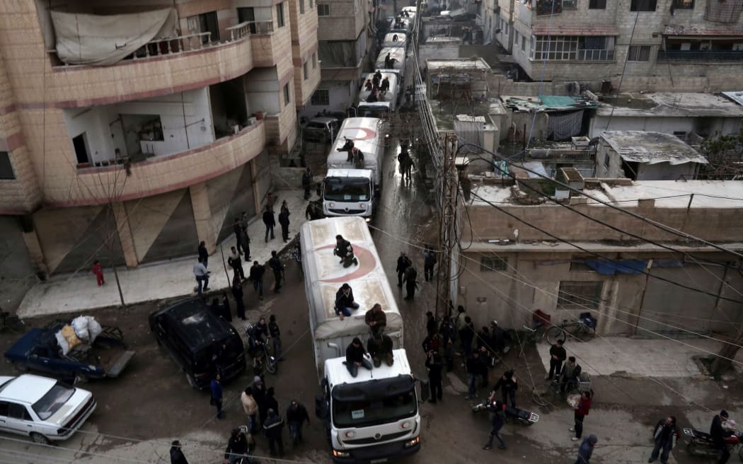 A Red Crescent aid convoy arrives in Kafr Batna on the outskirts of Damascus to deliver supplies to thousands of besieged Syrians.