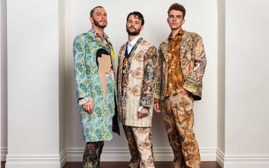 Image of three men in highly patterned suits - Vorakvong Chlong's 2023 entry for the Emerging Designer Award at 2023 iD Dunedin Fashion show.