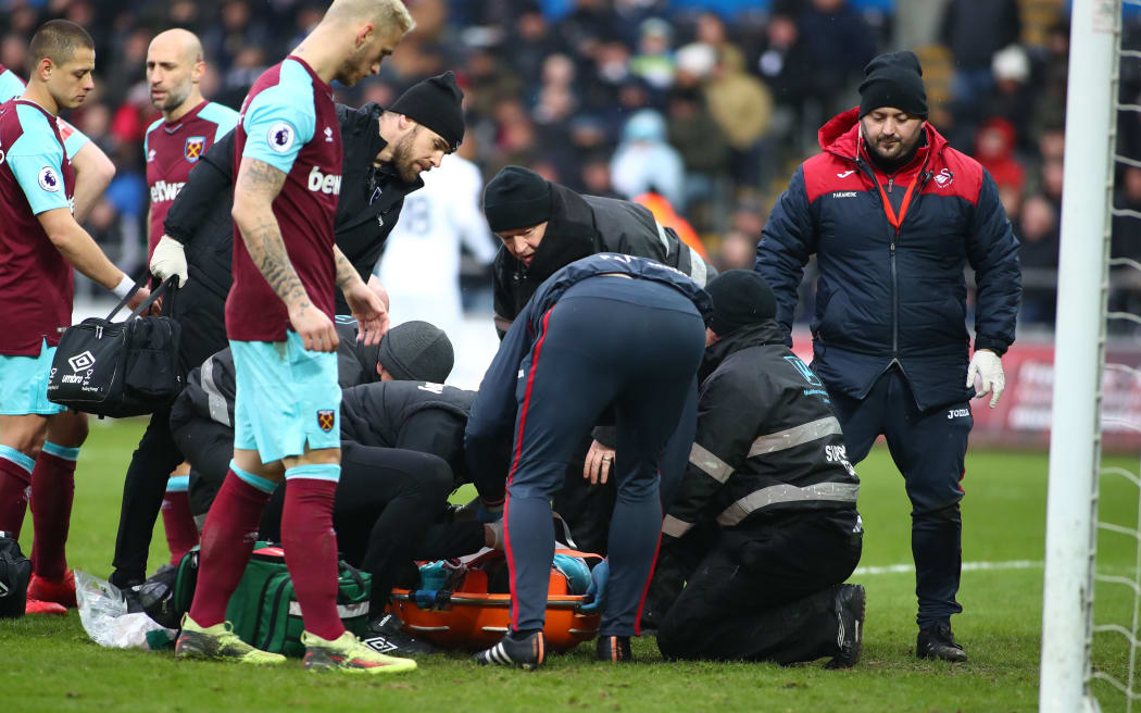 Winston Reid is placed onto a stretcher after a fall during West Ham United's clash with Swansea City.