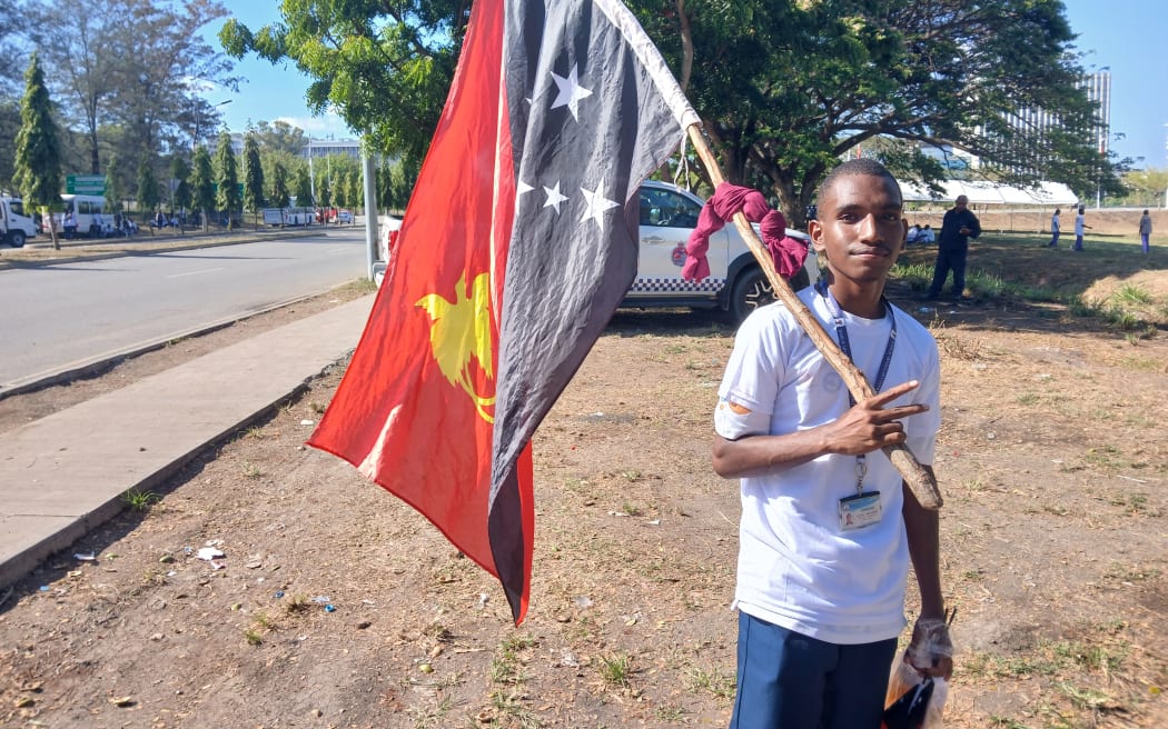 Along the roadside and across the city, PNG flags wave proudly,