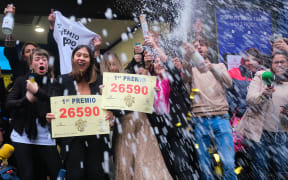 Madrid lottery shop Dona Manolita employees celebrate having sold the winning number in the €4m ''El Gordo'' (Fat One) Christmas lottery, on 22 December