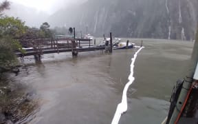 Booms are in place to contain the light oil slick