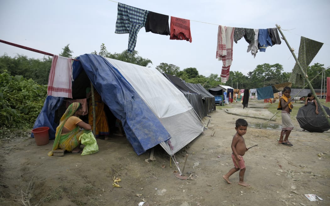 Flood affected people at a makeshift camp after flooding in their home in Barpeta, in India's northeastern state of Assam on 20 June, 2022.