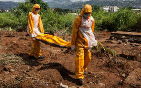 Funeral agents who specialise in the burial of Ebola victims at a cemetery in Freetown in Sierra Leone.
