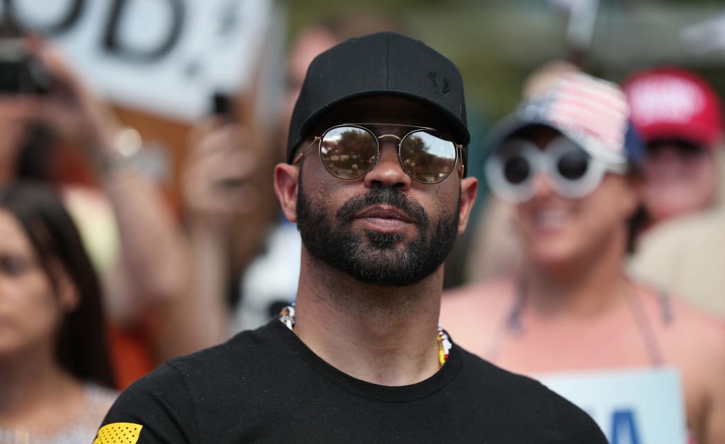 ORLANDO, FLORIDA - FEBRUARY 27: Enrique Tarrio, leader of the Proud Boys, stands outside of the Hyatt Regency where the Conservative Political Action Conference is being held on February 27, 2021 in Orlando, Florida.