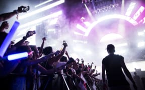 Japanese attend an electronic music concert during the Japan Ultra Music Festival at Odaiba Ultra Park in Tokyo on September 18, 2016.