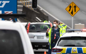 Police check motorists going on motorway in Auckland the day before the Easter long weekend begins.