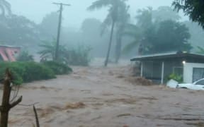 Homes engulfed by floodwaters during a cyclone in Fiji.