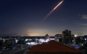 A missile launched from Iran is pictured in the sky from the Bureij camp for Palestinian refugees in the central Gaza Strip on March 1, 2026. The United States and Israel launched strikes against Iran on February 28, killing Iran's supreme leader and top military leaders, prompting authorities to retaliate with strikes on Israel and US bases across the Gulf. (Photo by Eyad Baba / AFP)