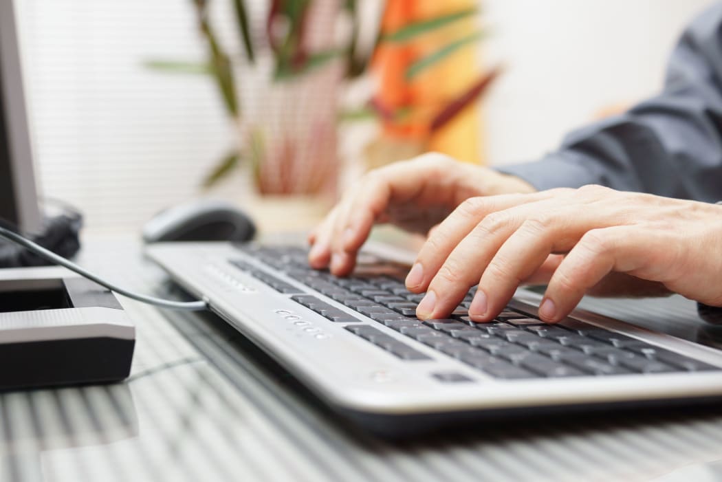 Man typing on a computer.