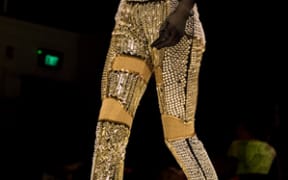 Yousef Akbar's mask and full beaded garments make a striking impact.