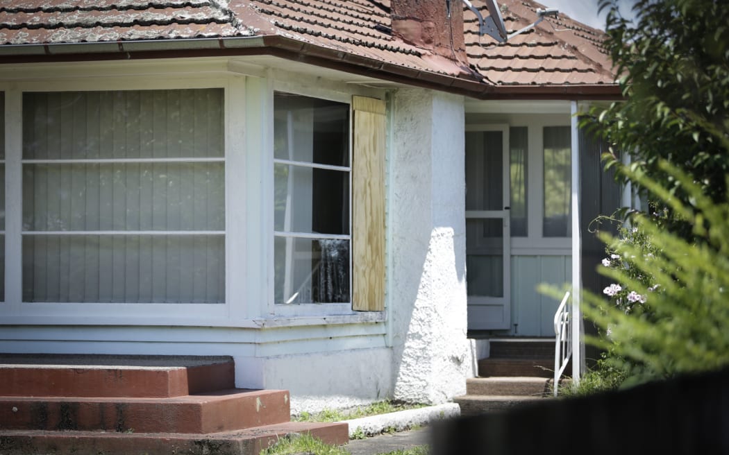 The house where an 88-year-old woman was harassed by a group of teenagers who broke a window and may have started a fire.
