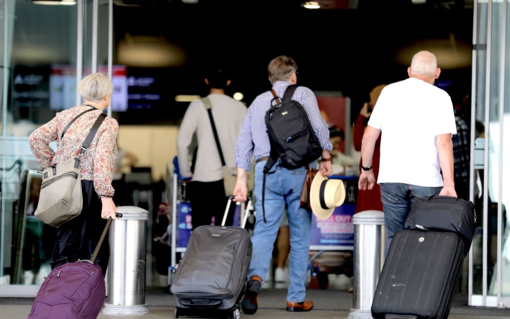Passengers enter the international terminal departures area at Auckland Airport on 11 December 2024.