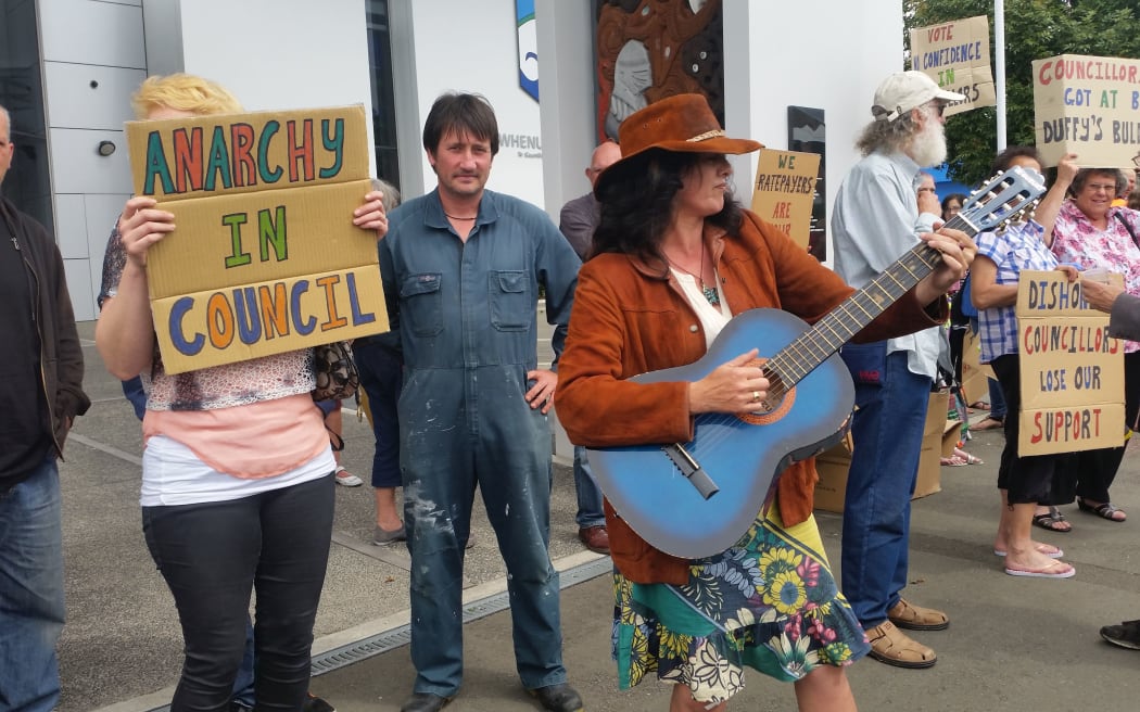 Protesters outside the Horowhenua District Council office in Levin, ahead of the Council's vote to strip Ross Campbell of the deputy mayor role.