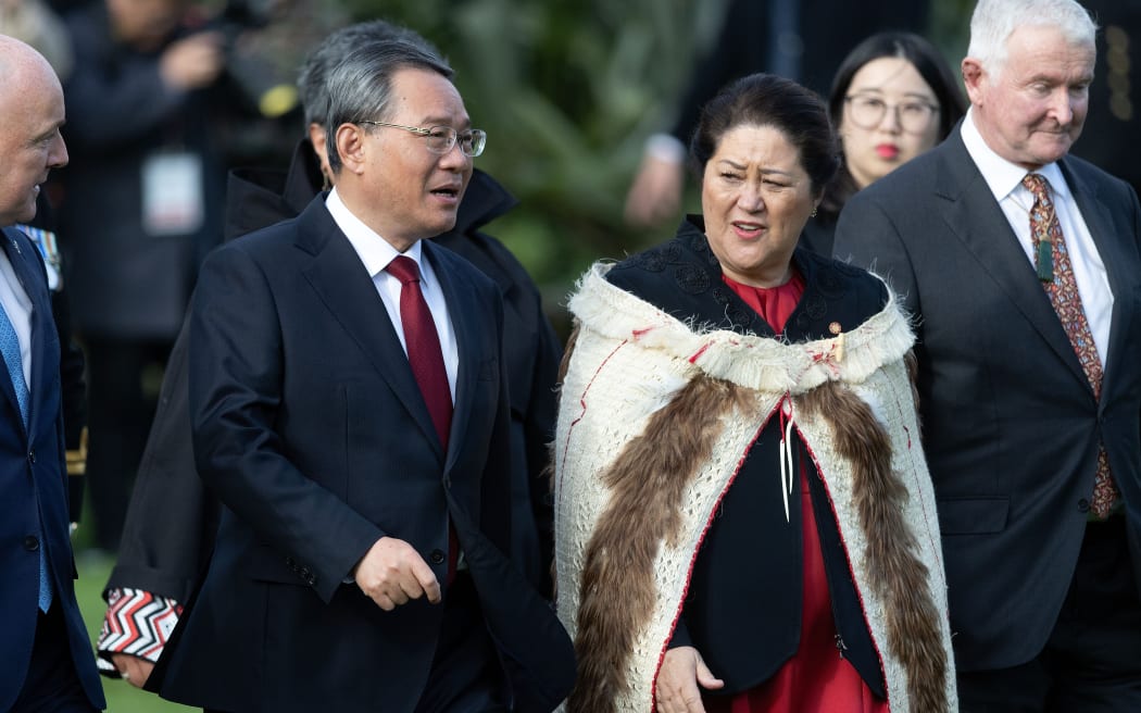 Chinese Premier Li Qiang (L) walks with Governor General of New Zealand Dame Cindy Kiro during a three day visit to New Zealand, at Government House on June 13, 2024. Pool Photo by Marty Melville/AFP
