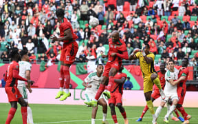 Sudan's midfielder Salaheldin Adil jumps for the ball during the Africa Cup of Nations match against Algeria.