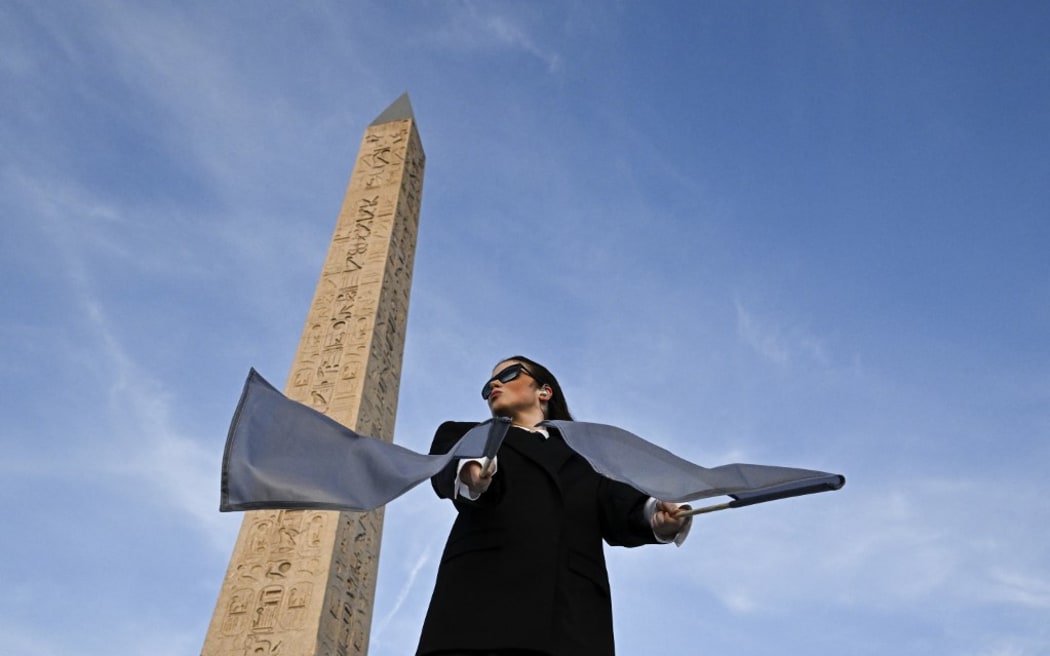 Dancers perform during the Paris 2024 Paralympic Games Opening Ceremony at the Place de la Concorde in Paris, with the Obelisque de Louxor (Luxor Obelisk) on August 28, 2024. (Photo by JULIEN DE ROSA / POOL / AFP)