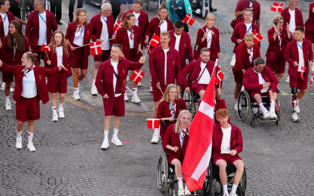Denmark's delegation parade on the Champs-Elysees avenue during the Paris 2024 Paralympic Games Opening Ceremony in Paris on August 28, 2024. (Photo by Dimitar DILKOFF / AFP)