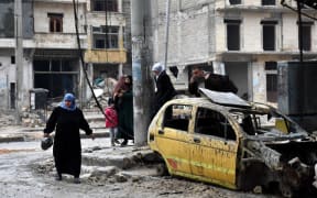 Syrian civilians from the al-Sukari neighbourhood flee on December 14 2016.