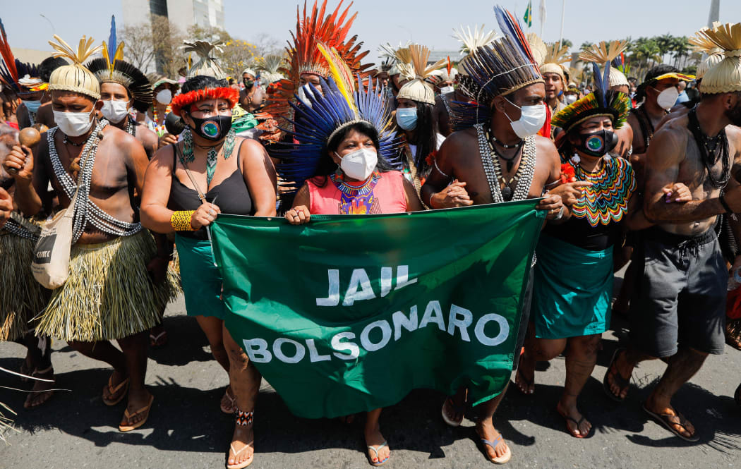 Indigenous people protest in front of the Planalto Palace in Brasilia on August 26, 2021.