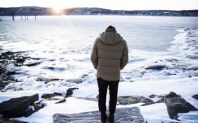 A man stands near the frozen Hudson River on 5 January.