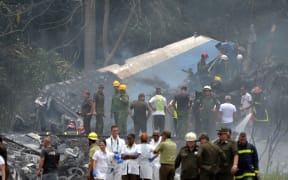 Emergency personnel work at the site of the accident after a Cubana de Aviacion aircraft crashed after taking off from Havana's Jose Marti airport.