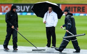 3rd Umpire Marais Erasmus checks out the wicket block with the groundsman.