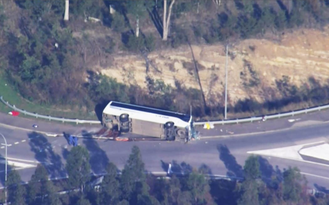 This frame grab taken from video footage provided by the Australian Broadcast Corporation (ABC) on 12 June, 2023 via AFPTV shows the site of a bus crash, where 10 people from a wedding party were killed, in Cessnock, in Australia's Hunter wine region north of Sydney.