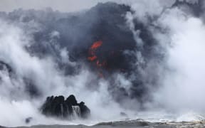 A steam plume rises as lava enters the Pacific Ocean, after flowing to the water from a Kilauea volcano fissure.