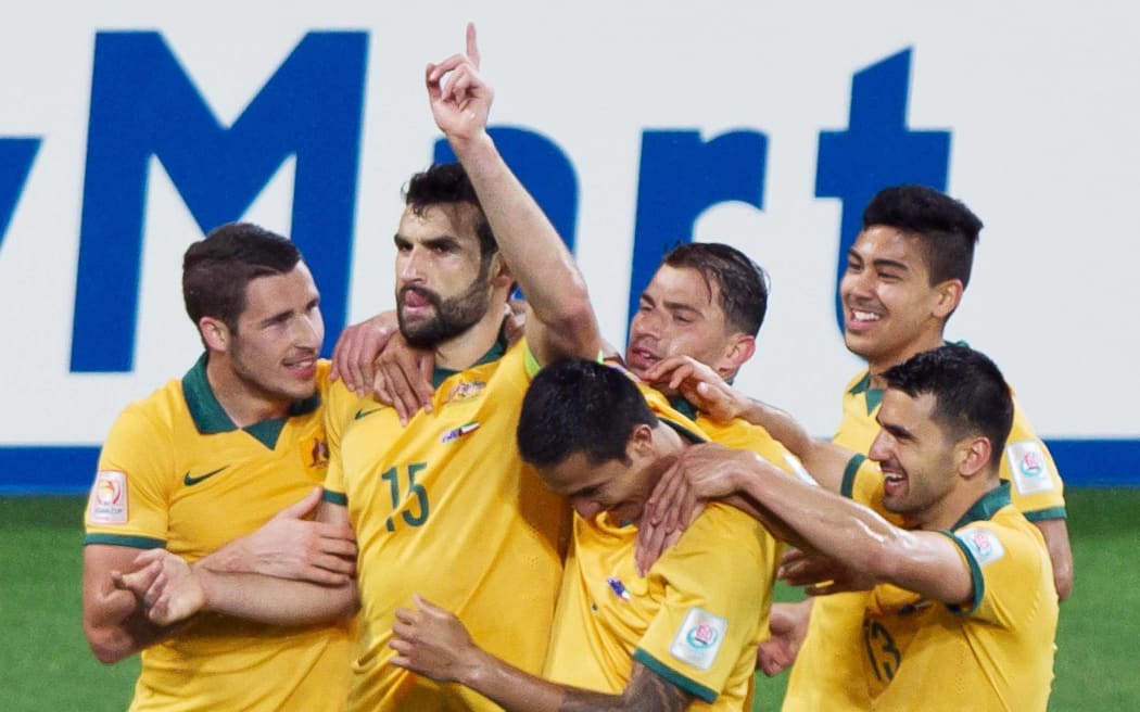 Australia midfielder Mile Jedinak celebrates a goal for Australia.