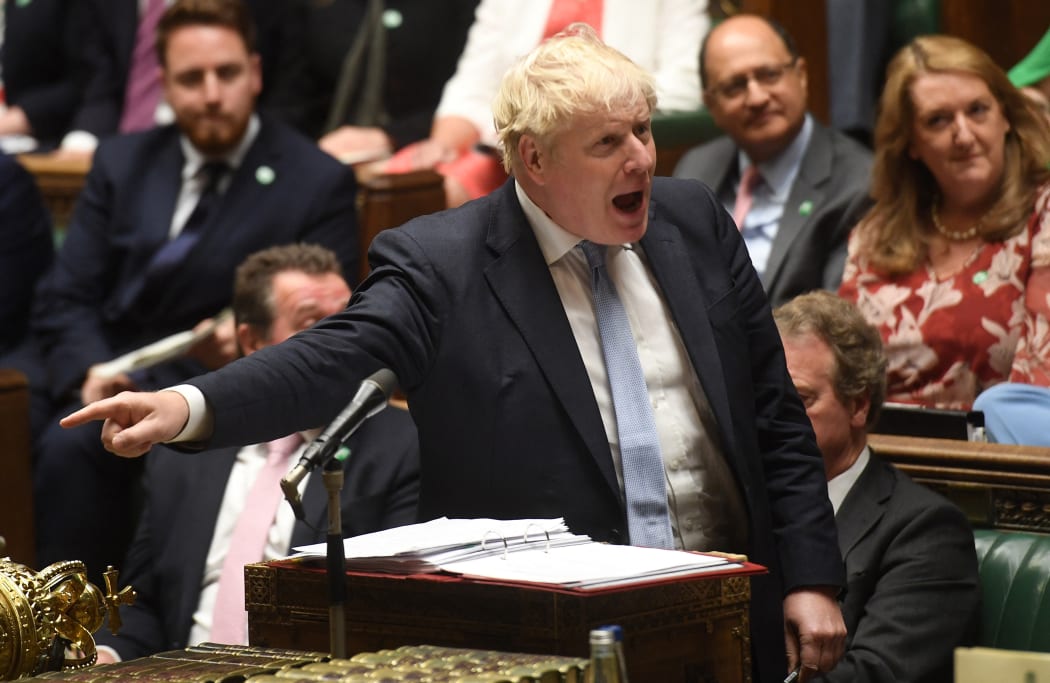 A handout photograph released by the UK Parliament shows Britain's Prime Minister Boris Johnson speaking during the weekly Prime Minister's Questions (PMQs) session in the House of Commons in London on September 8, 2021.