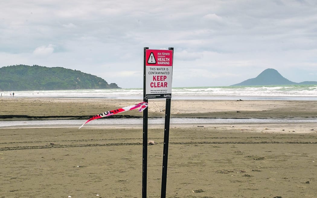 Signs warn beachgoers not to swim on Ōhope Beach in the area surrounding Wharekura Stream.