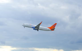 A Sunwing passenger jet can be seen above Trudeau Airport in Montreal, Canada on 3 July, 2016.